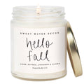 Glass jar candle with 'Hello Fall' label, lit wick, white wax, cider and cinnamon apples scent