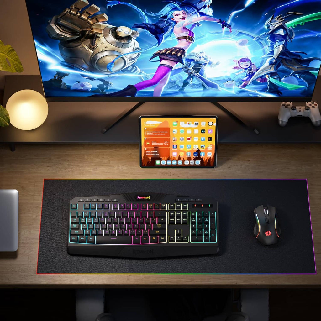 Gaming keyboard and wireless mouse set on desk, black with multicolor RGB lighting