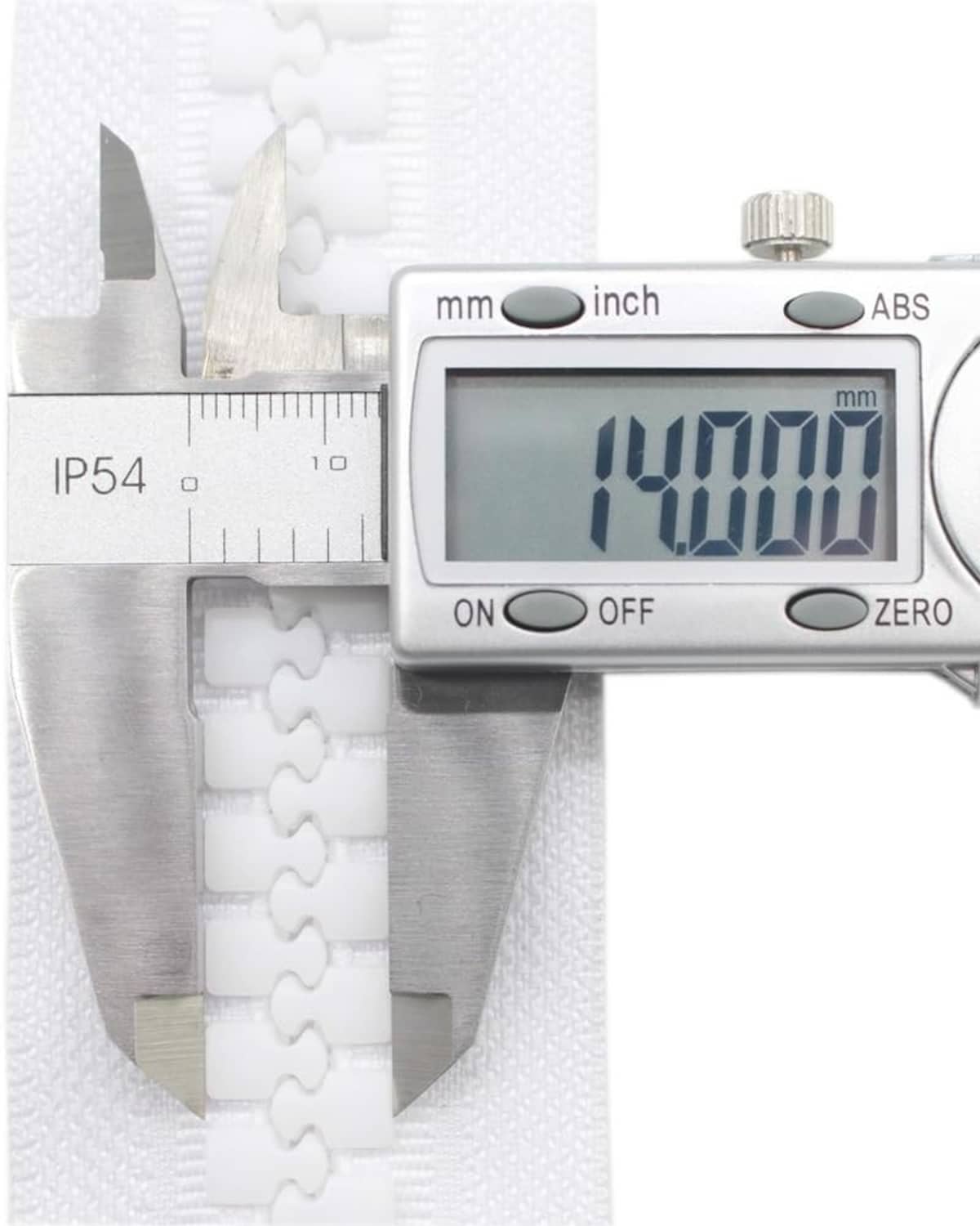 White zipper tape with plastic teeth beside digital caliper measurement