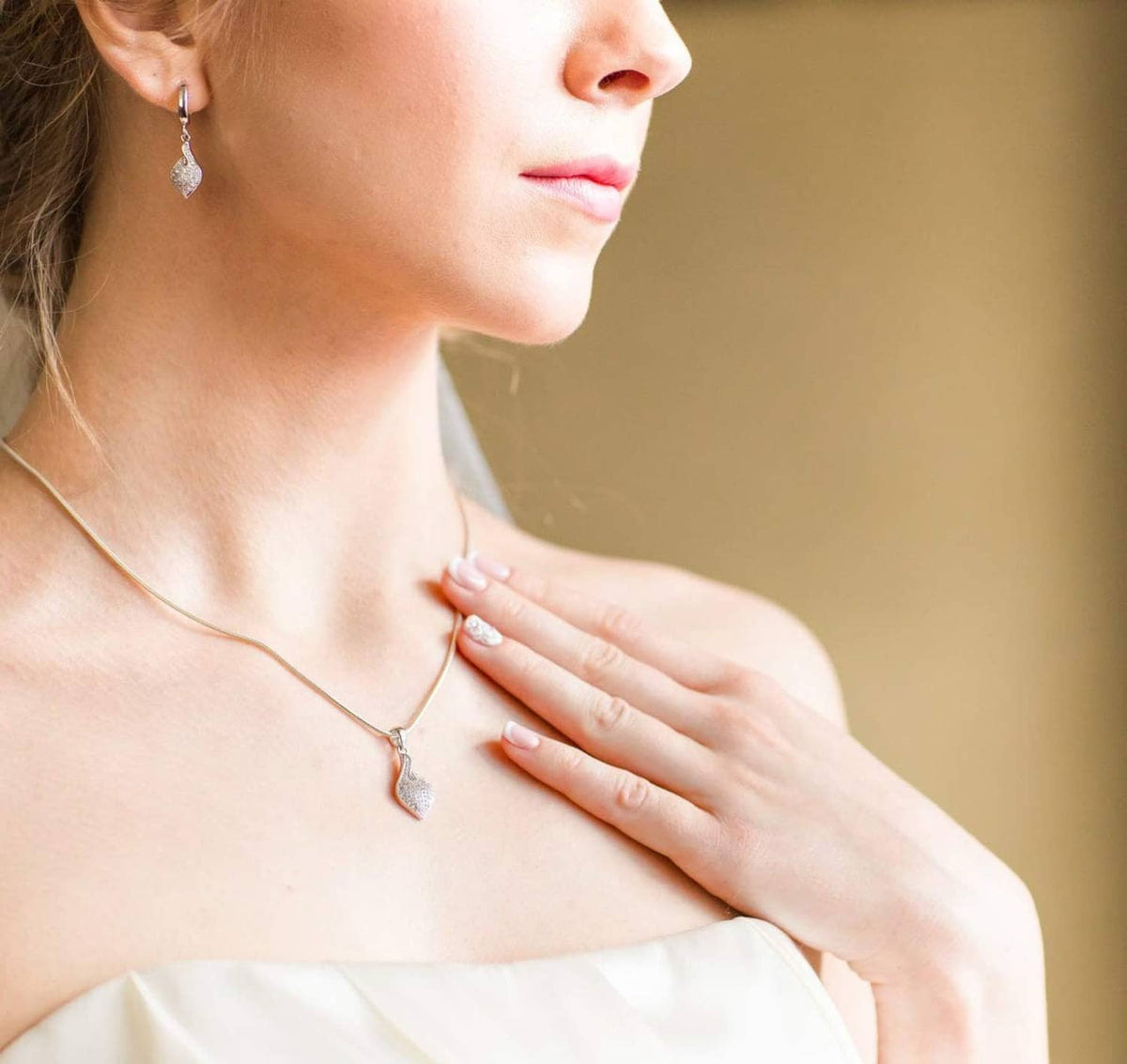 Silver-plated snake chain necklace with small dangling charm pendant