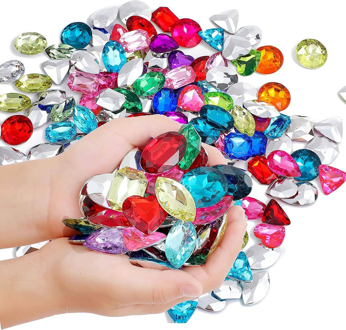 Hand holding assorted multi-colored faceted rhinestone jewels, mixed shapes