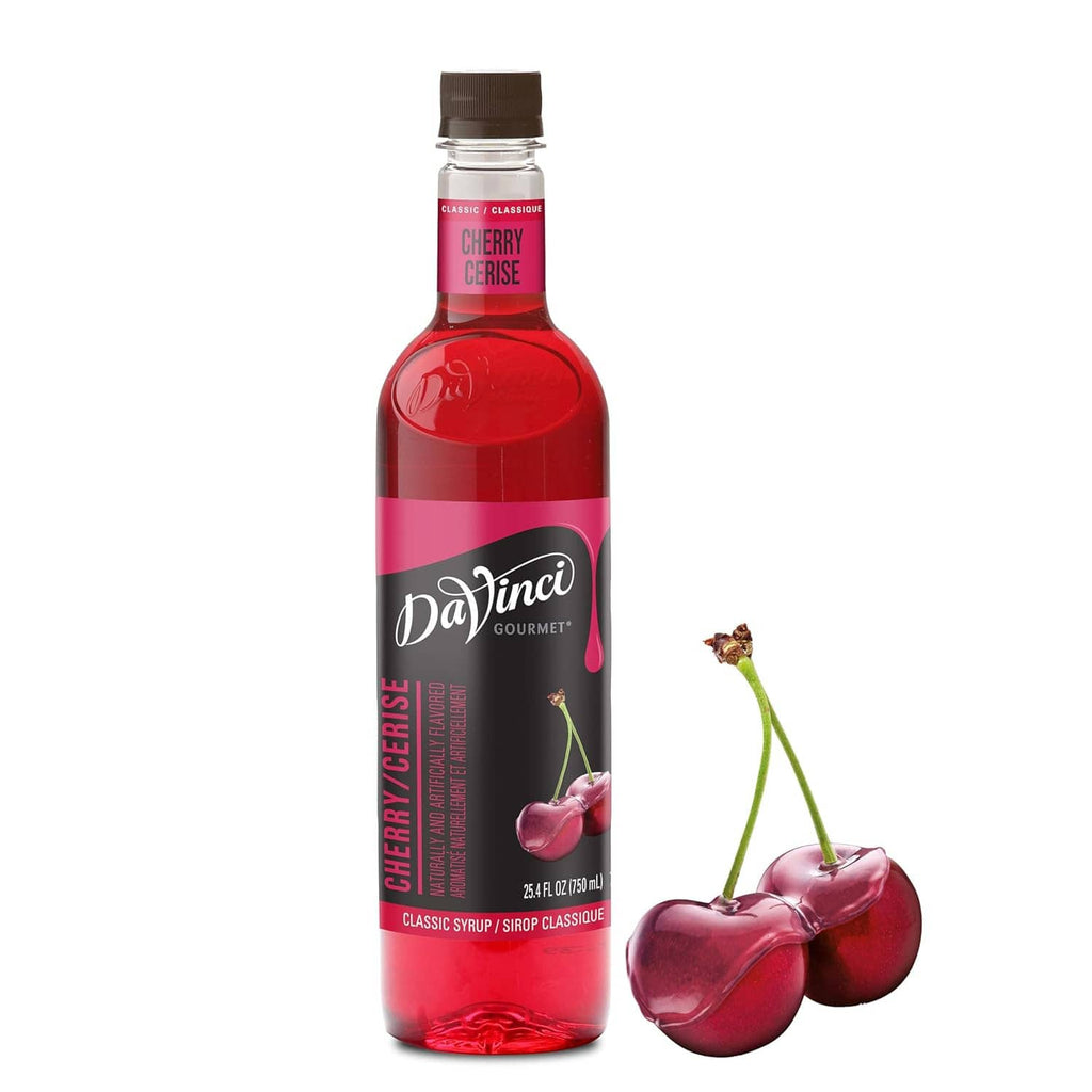 Cherry syrup bottle with DaVinci Gourmet label next to two cherries