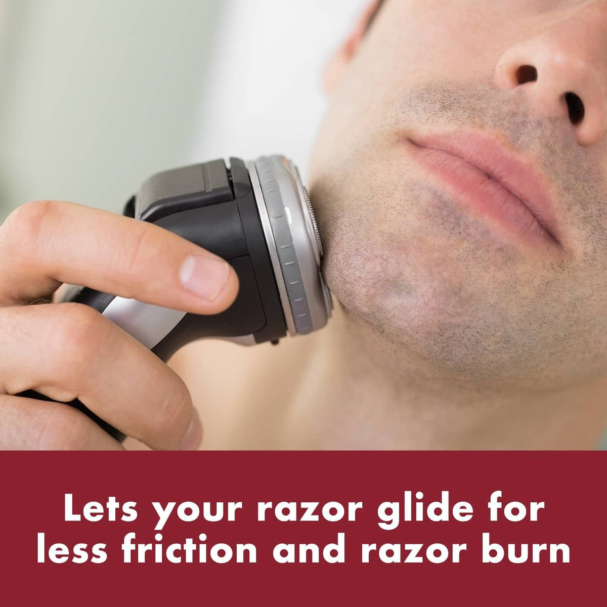 Electric razor blade gliding on a man's chin with pre-shave applied
