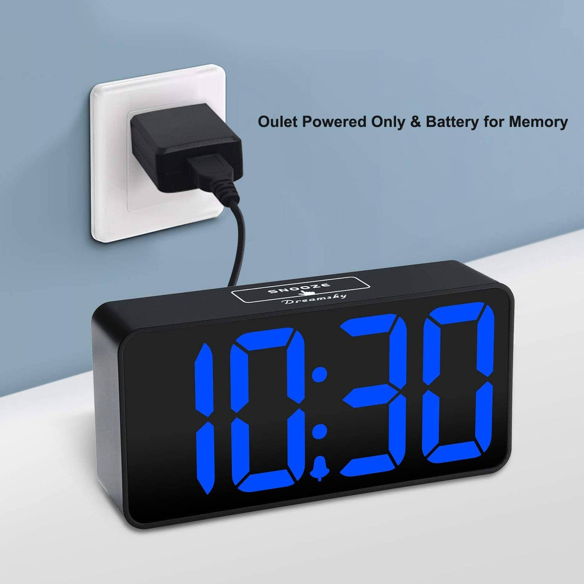 Digital alarm clock with large blue LED digits and wall power plug with cable