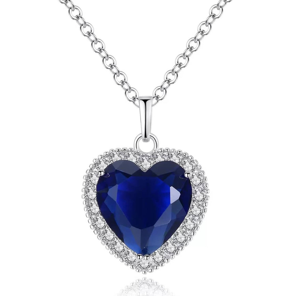 Silver heart pendant necklace with blue faceted gemstone and crystal halo