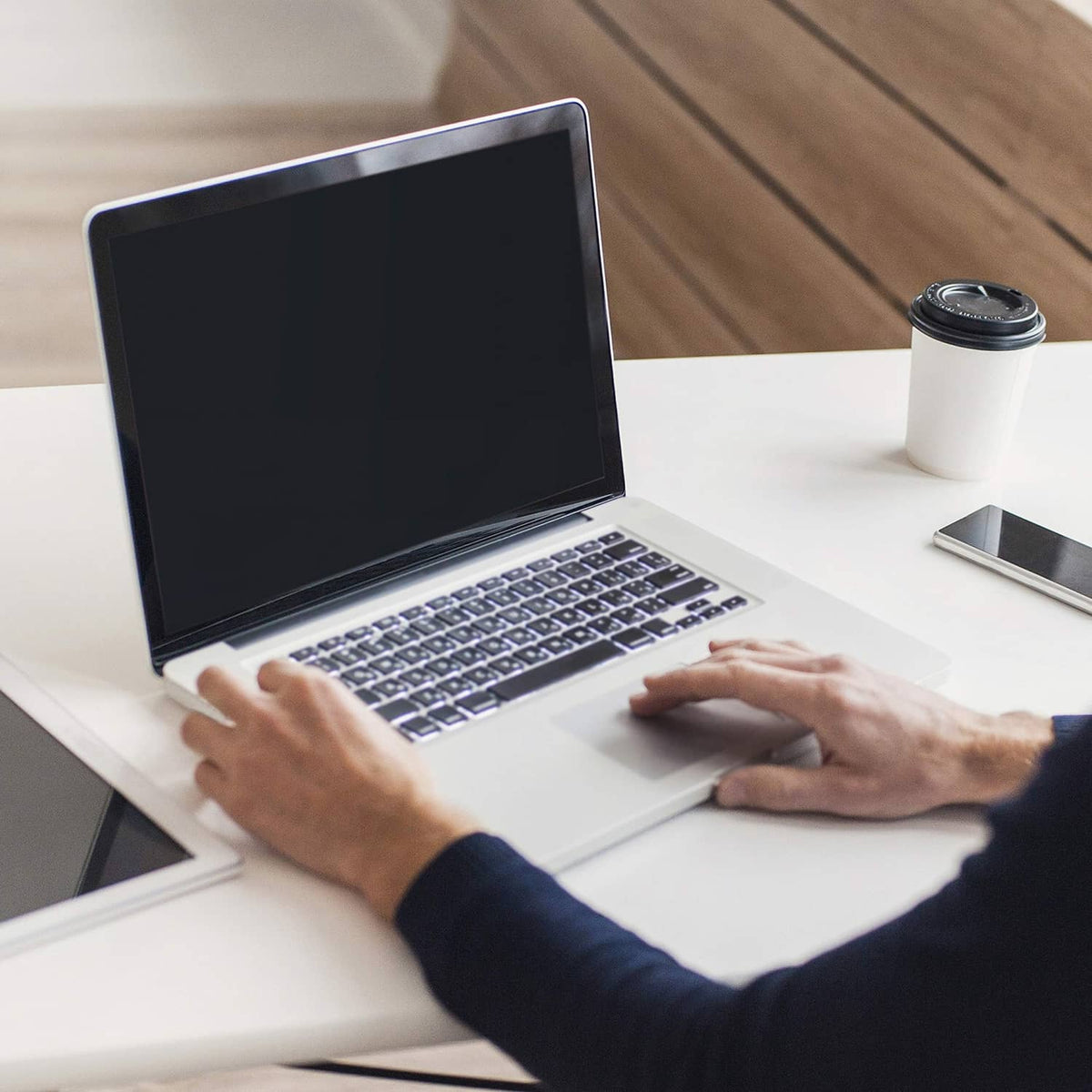 Laptop in use with hands on keyboard and trackpad