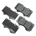 Brake pad set with four grey ceramic brake pads with mounting holes