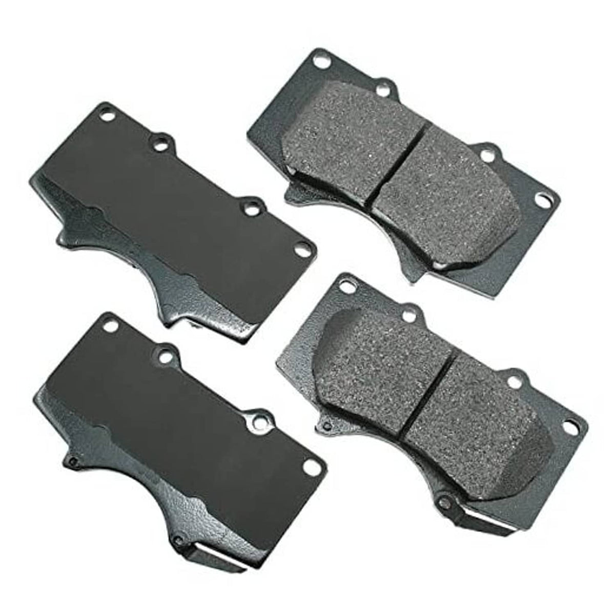 Brake pad set with four grey ceramic brake pads with mounting holes