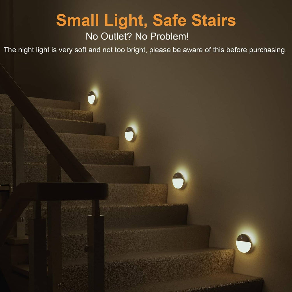 Multiple round motion sensor night lights on a stairway, glowing warm yellow.