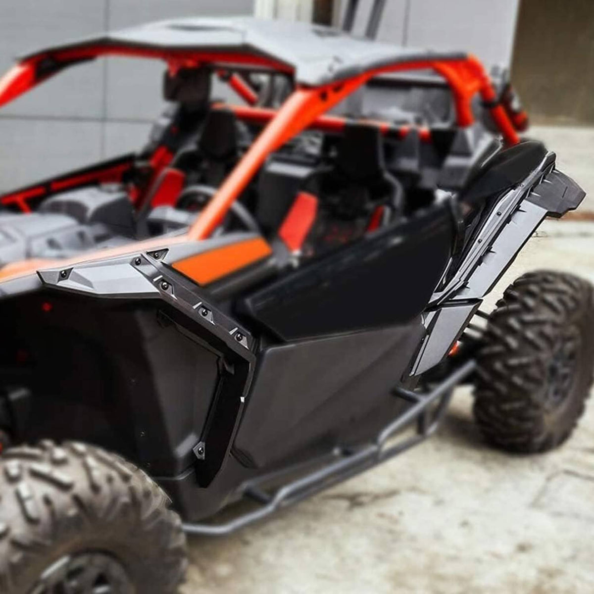 Installed black fender flare on UTV side near the rear wheel