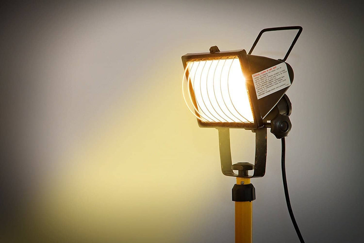 Halogen floodlight fixture with lit reflector head and mounted bulb socket