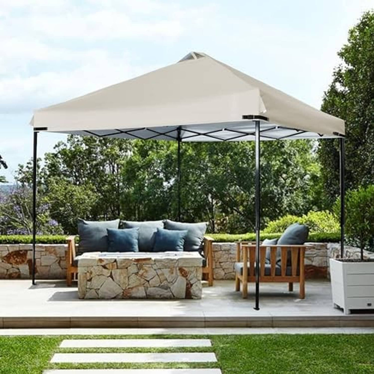 Beige outdoor canopy with vented top and black metal frame