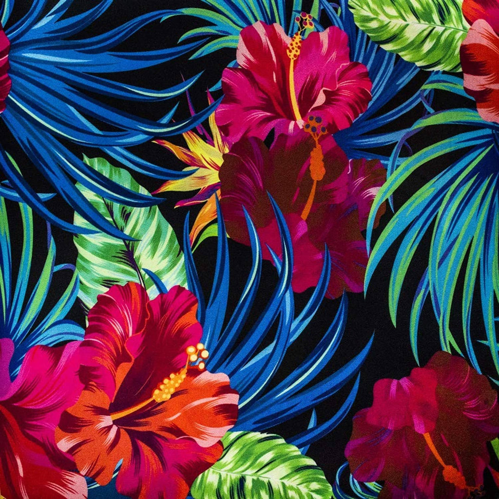 Close-up tropical floral fabric pattern in vivid pink, blue, and green.