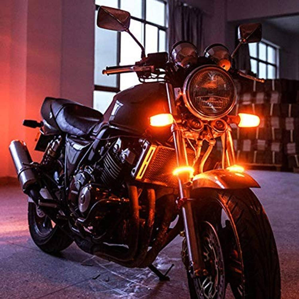 Motorcycle front with amber turn signal glow from LED fork turn lights