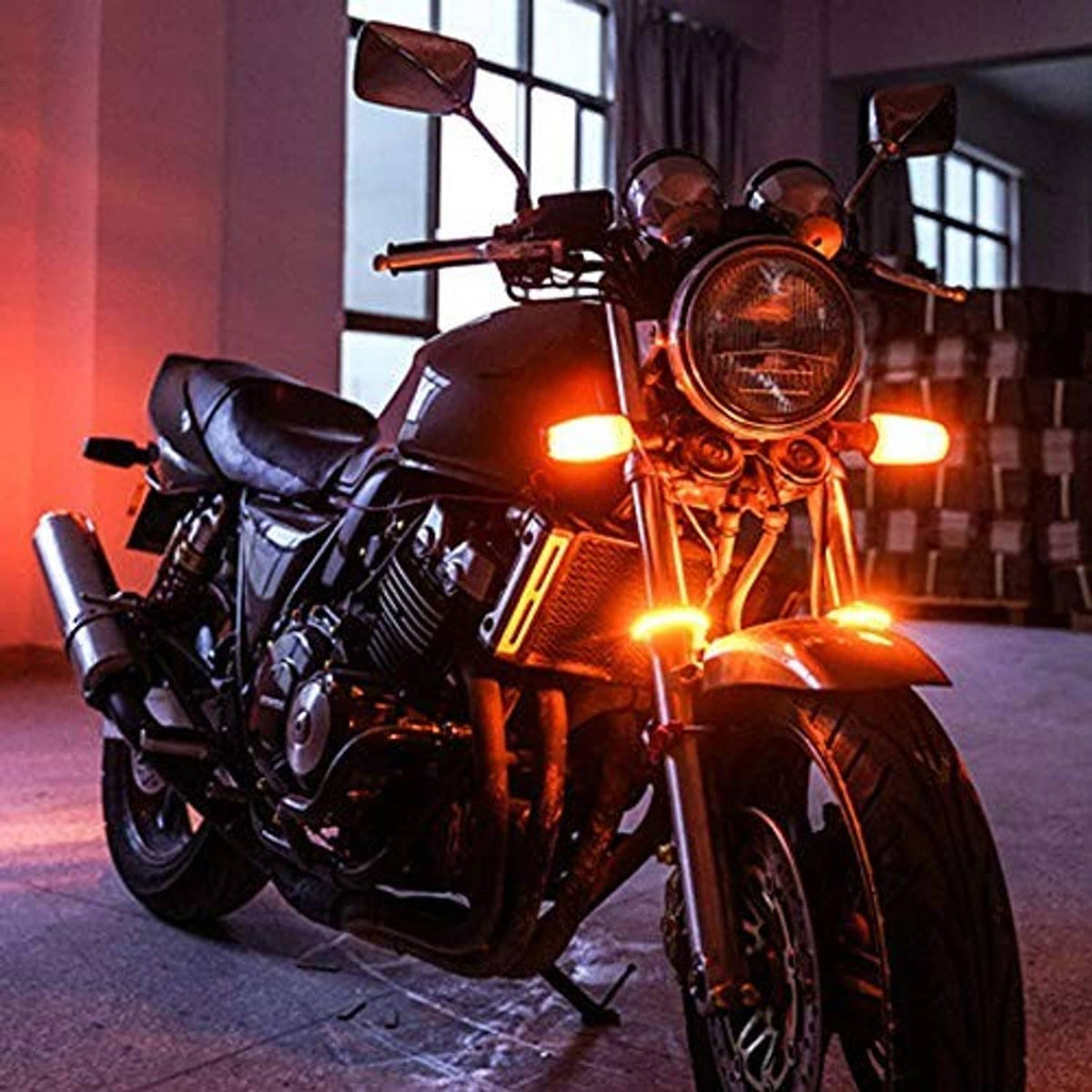Motorcycle front with amber turn signal glow from LED fork turn lights