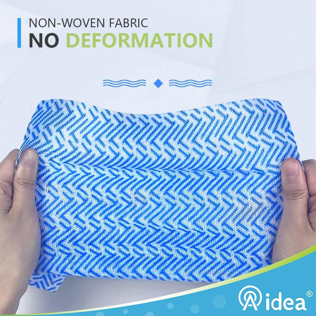 Blue non-woven cleaning cloth with zigzag texture, held between two hands.