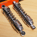 Pair of chrome rear shocks with black coil springs and silver mounting brackets