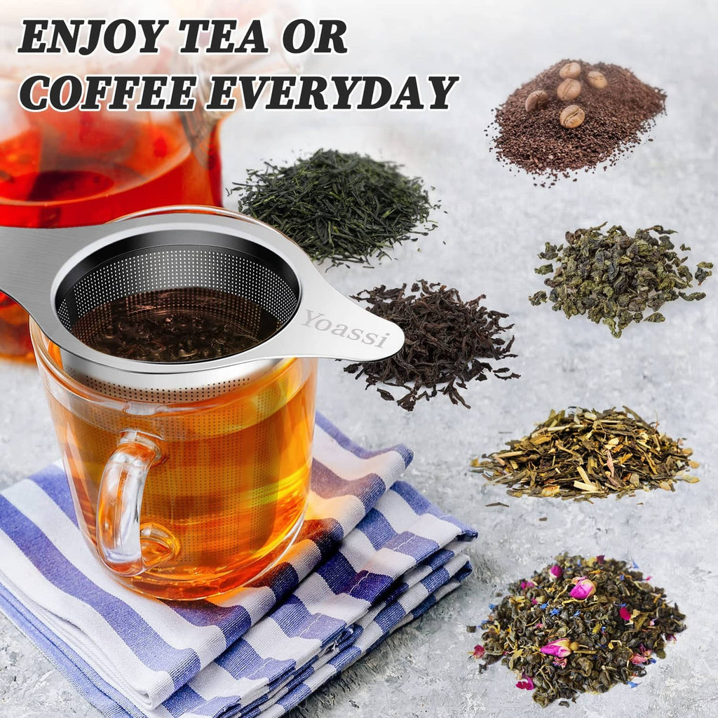 Stainless steel tea infuser mesh basket resting on tea cup with loose tea leaves