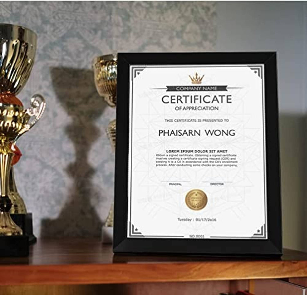 8.5x11 certificate frame with dark border, standing on a wooden surface