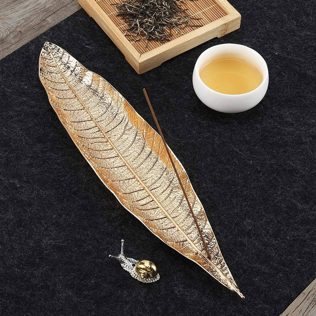 Two leaf incense trays with etched gold finish and matching snail incense holders