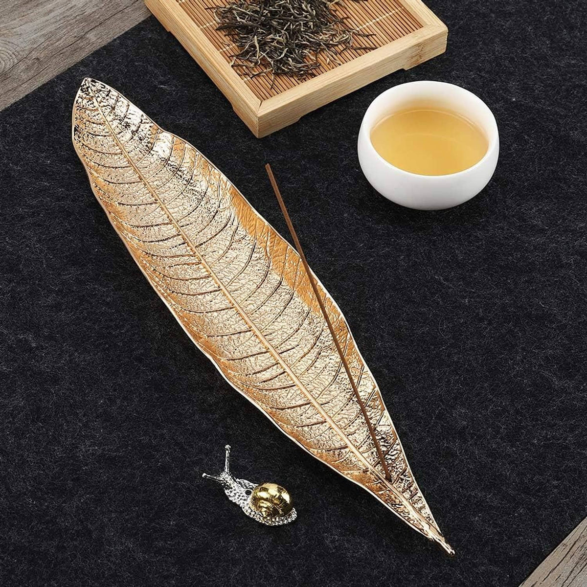 Two leaf incense trays with etched gold finish and matching snail incense holders