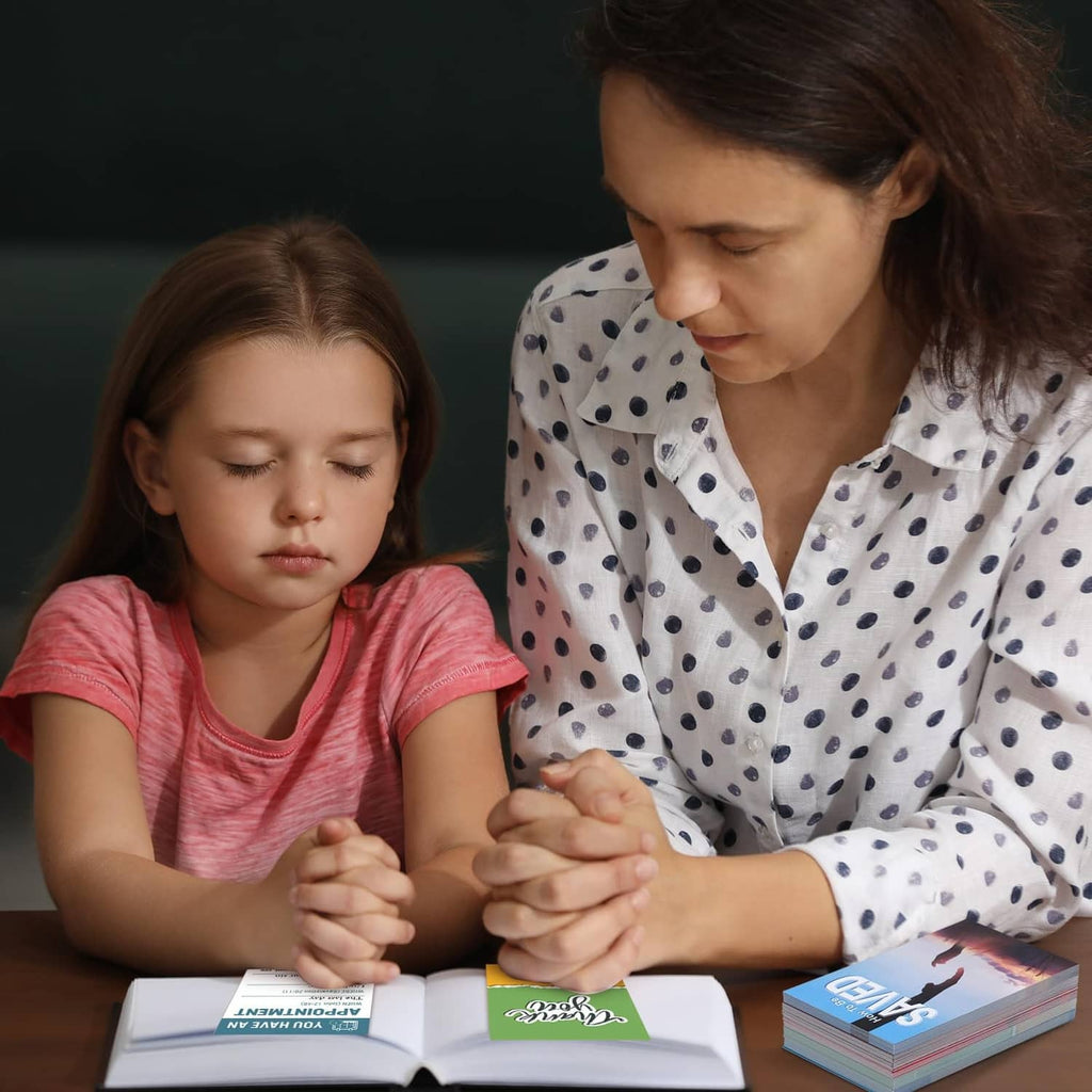 Gospel tract cards on table while woman and child read together