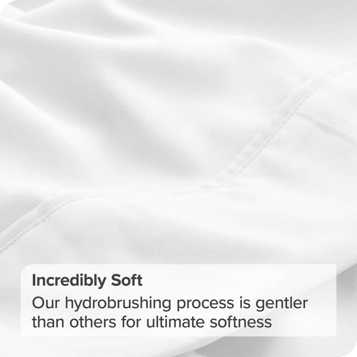 Close-up of white twin flat sheet fabric with fine brushed texture and stitched edge