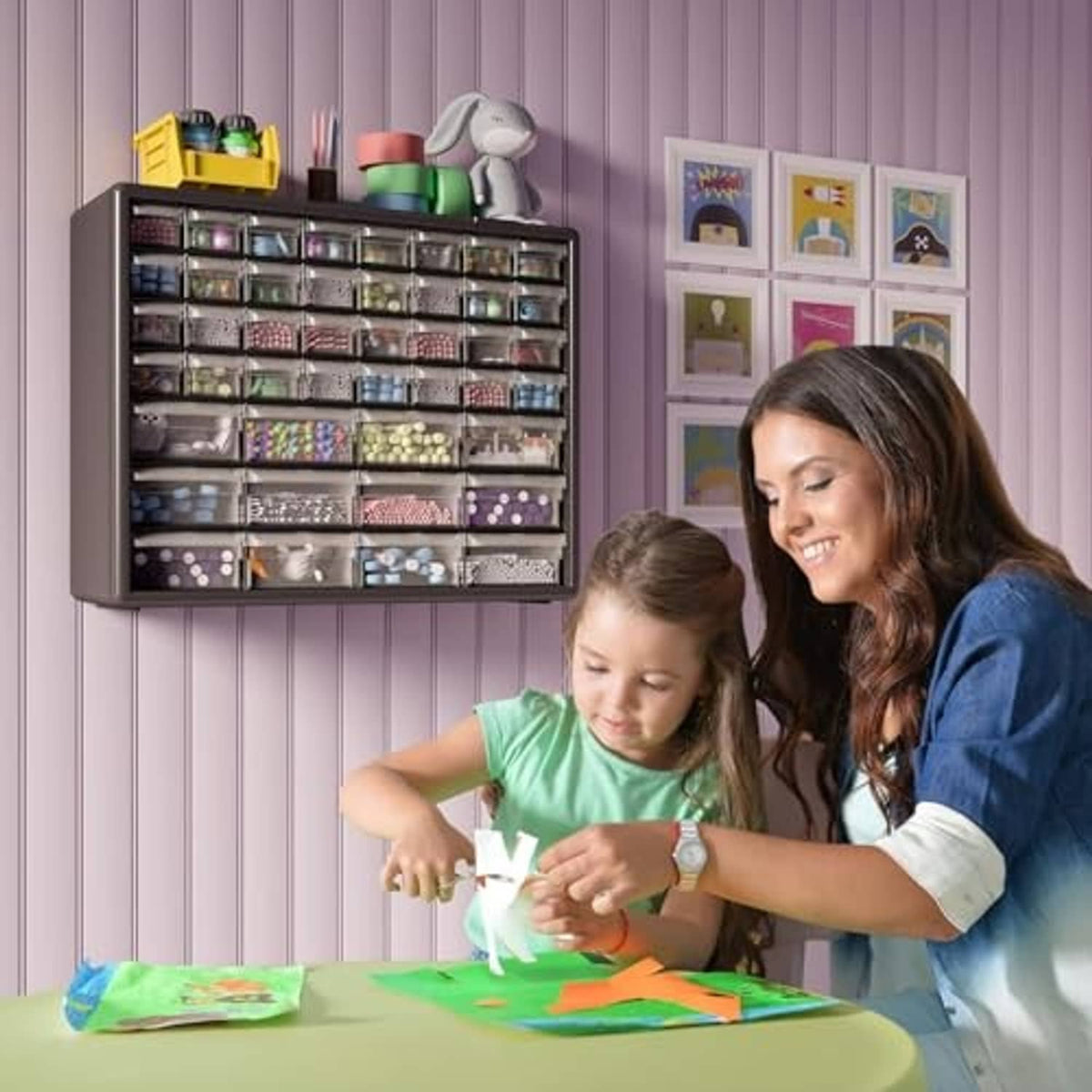 Plastic drawer storage cabinet mounted on wall with many small clear drawers