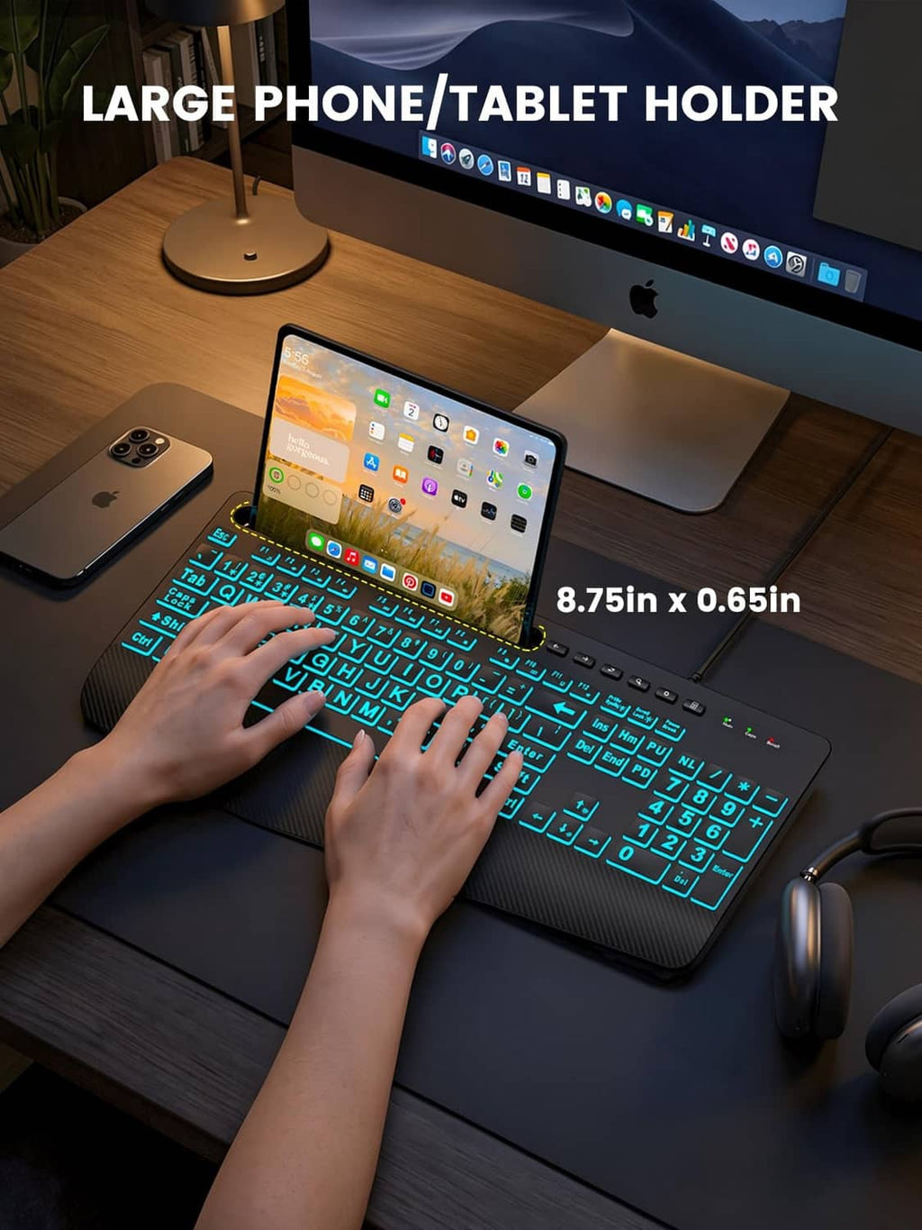 Black backlit wired keyboard with blue keys beside tablet and phone holder