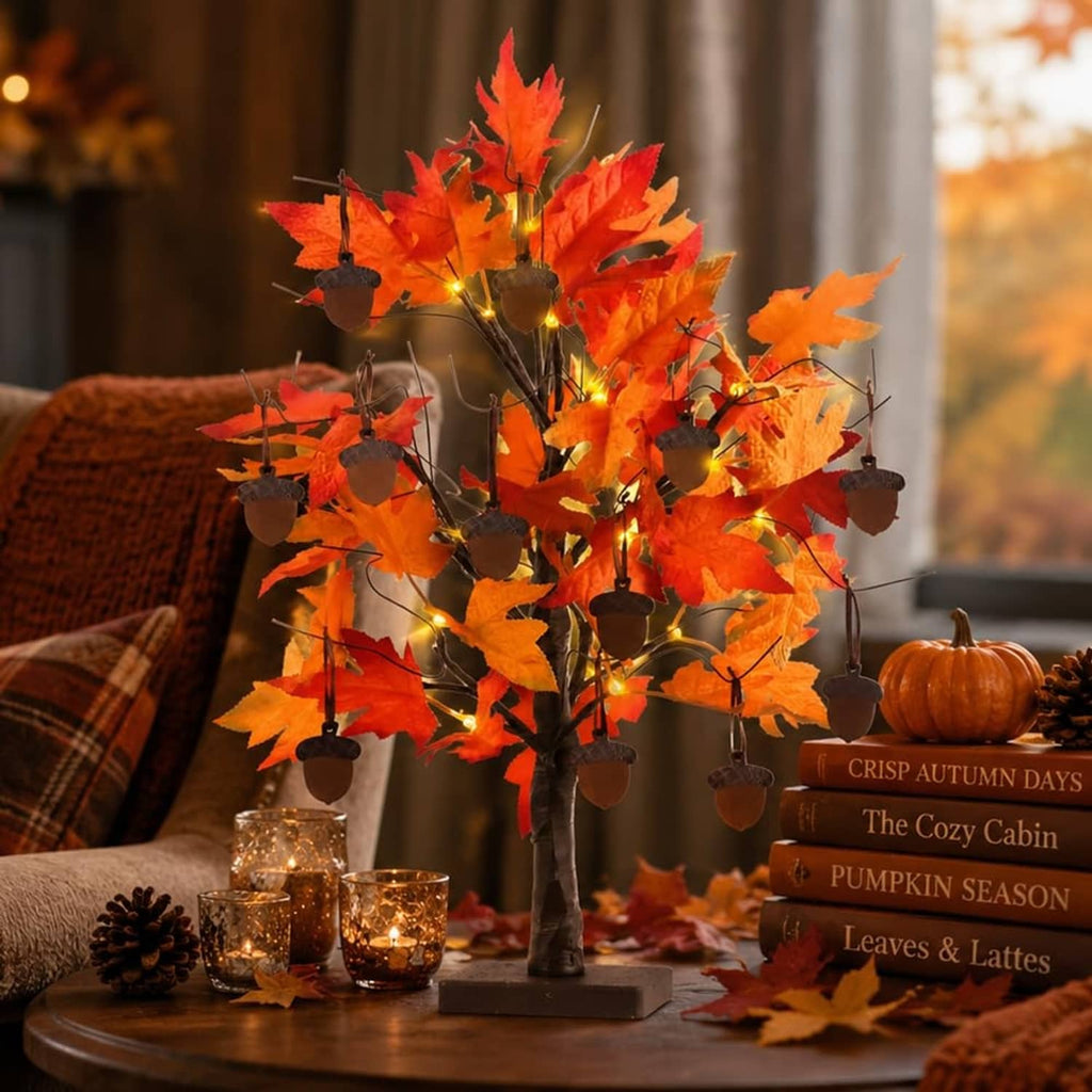Orange lit maple leaf tabletop tree decoration with warm LED bulbs and dangling acorns