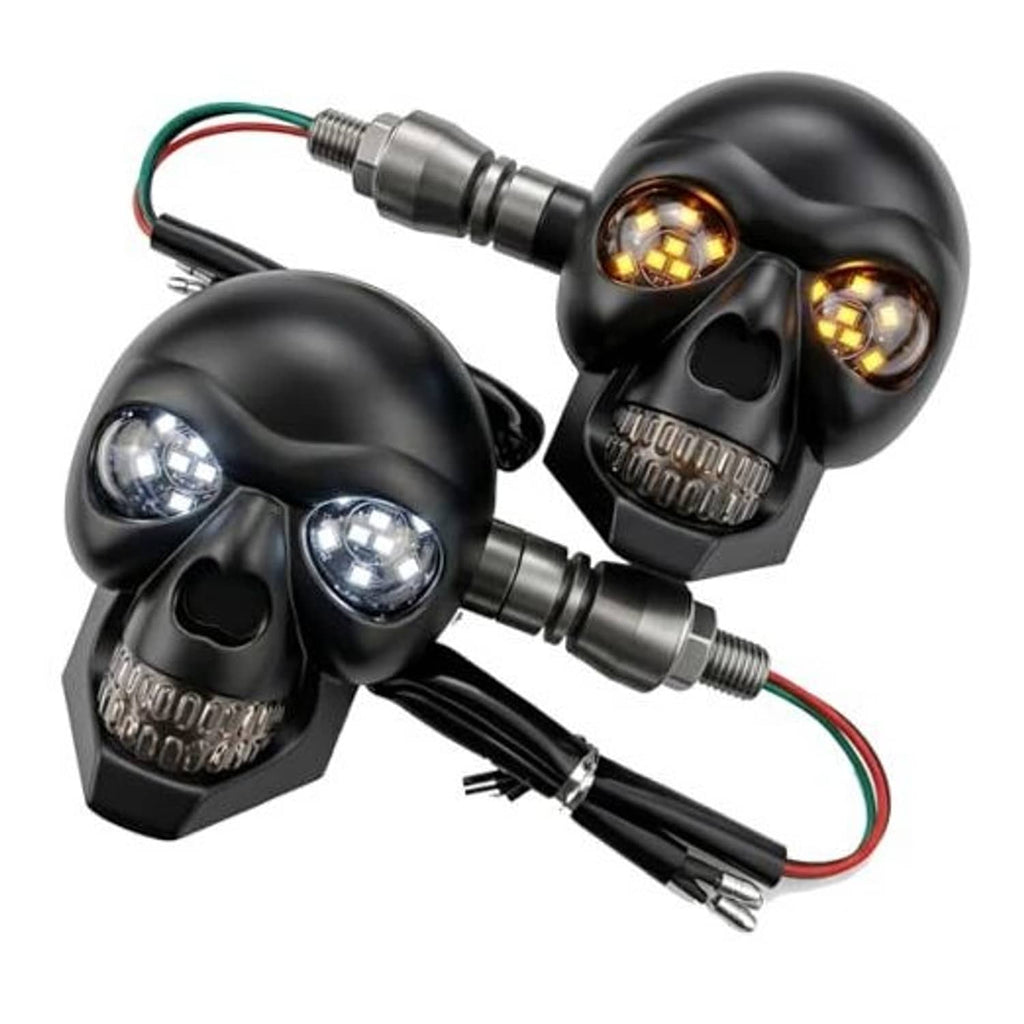 Pair of black skull motorcycle LED turn signal lights with amber bulbs and wiring leads