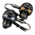 Pair of black skull motorcycle LED turn signal lights with amber bulbs and wiring leads