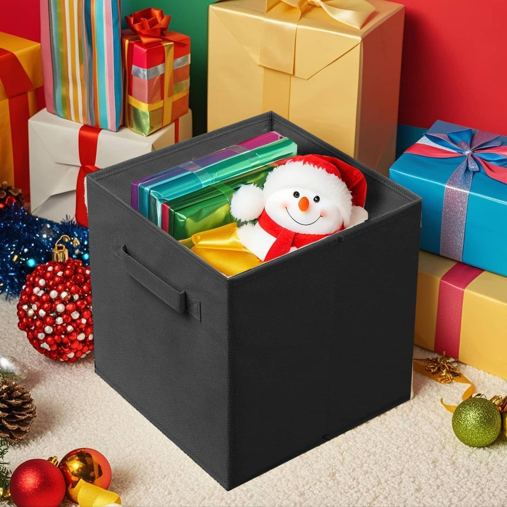 Black foldable fabric storage cube with handles holding a stuffed snowman