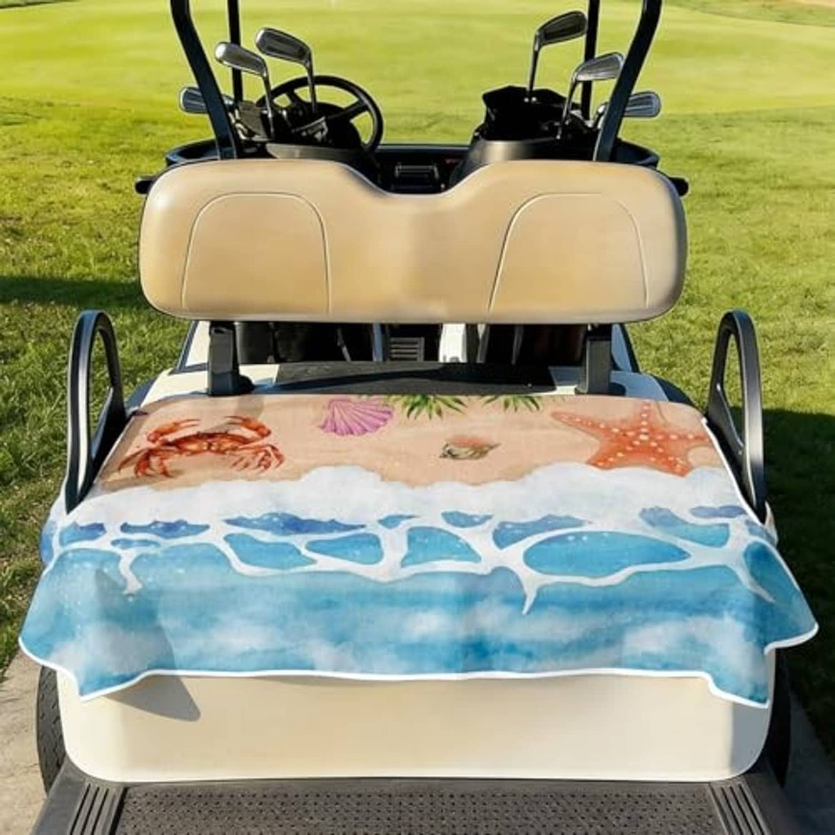 Front-facing golf cart seat cover with blue ocean waves and crab, starfish, shell artwork