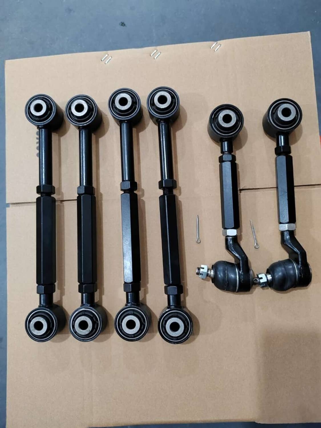 Six black rear upper and lower control arms with bushings and ball joints