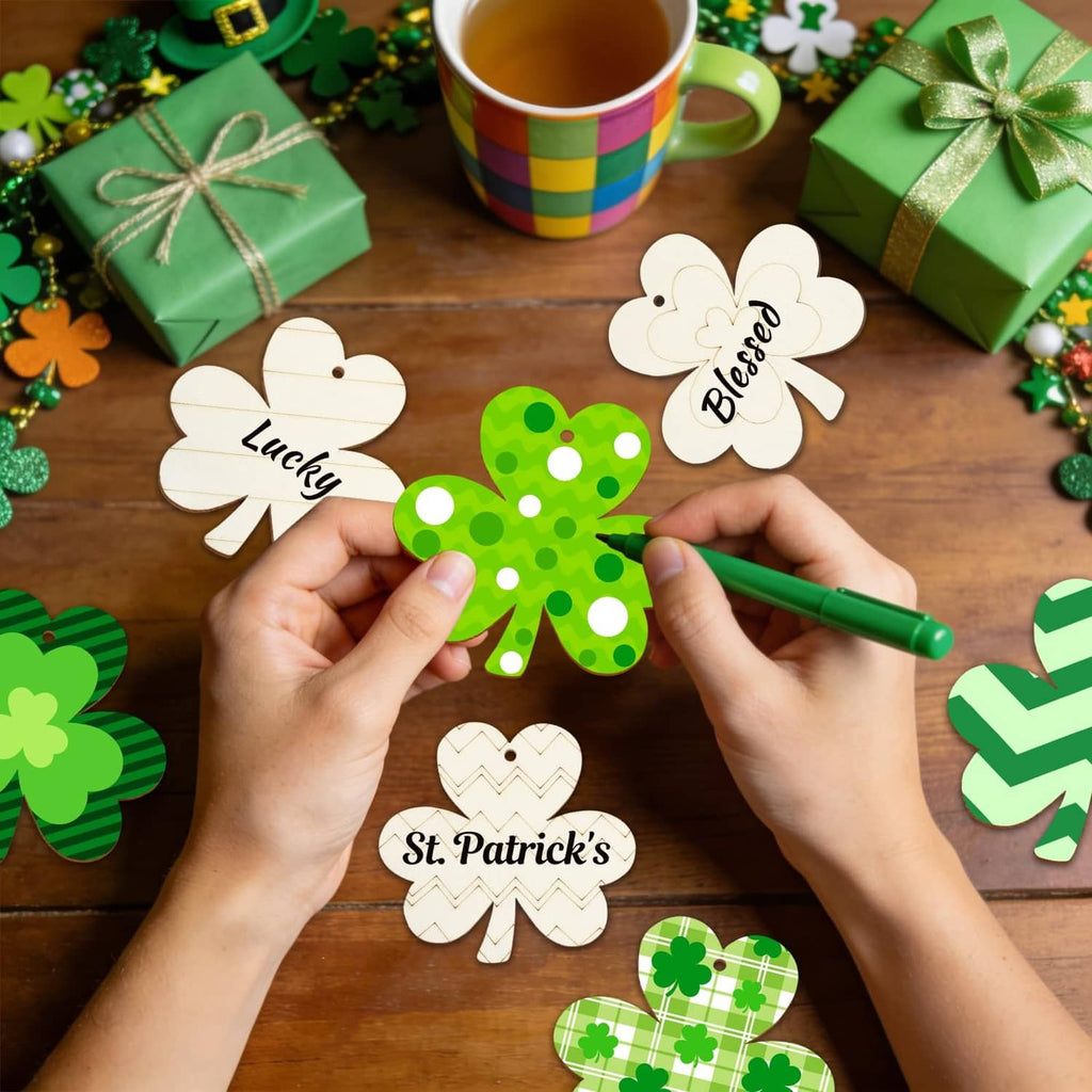 Hands painting a green wooden shamrock ornament with a marker