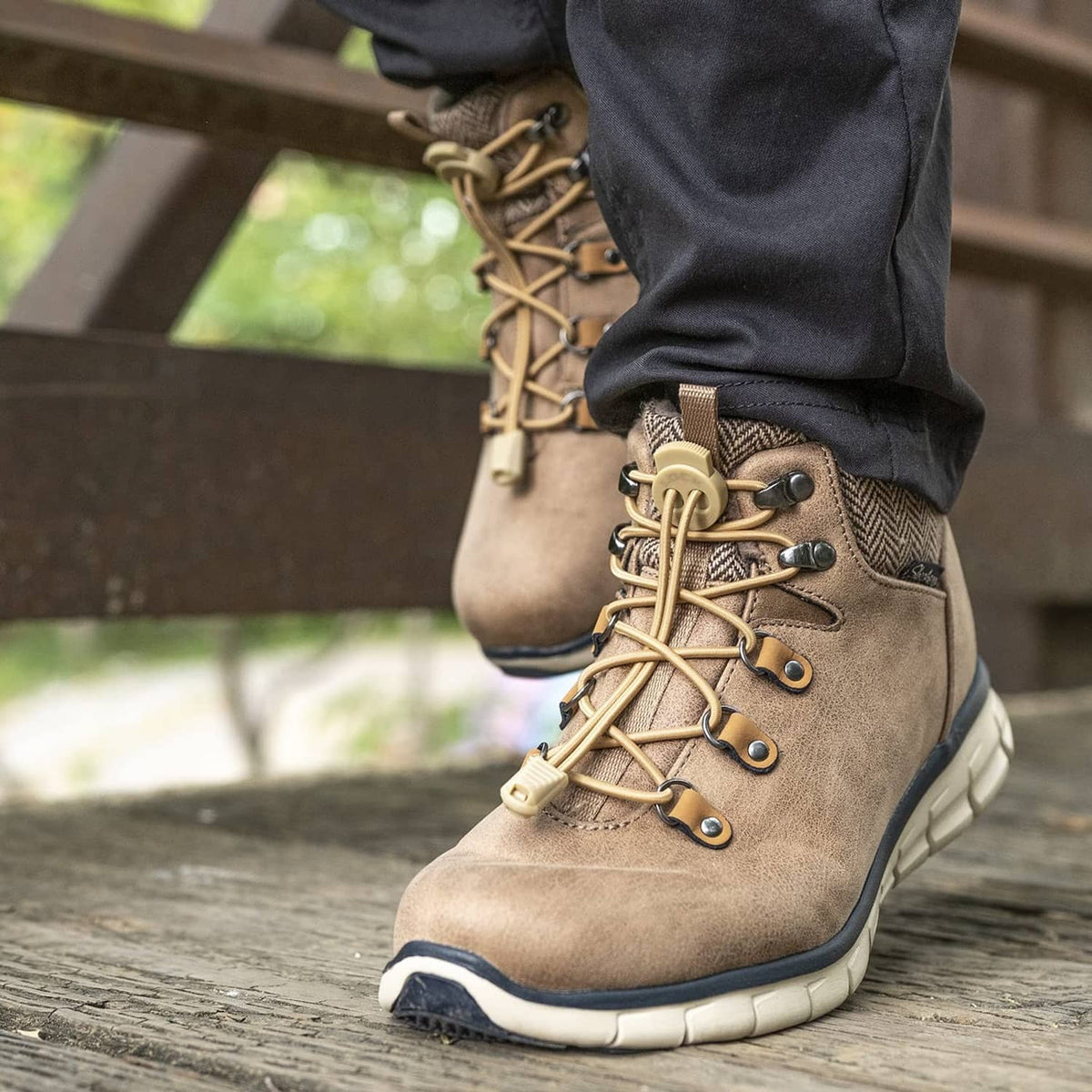 Tan boot with elastic no-tie laces, metal eyelets, and beige lock toggle