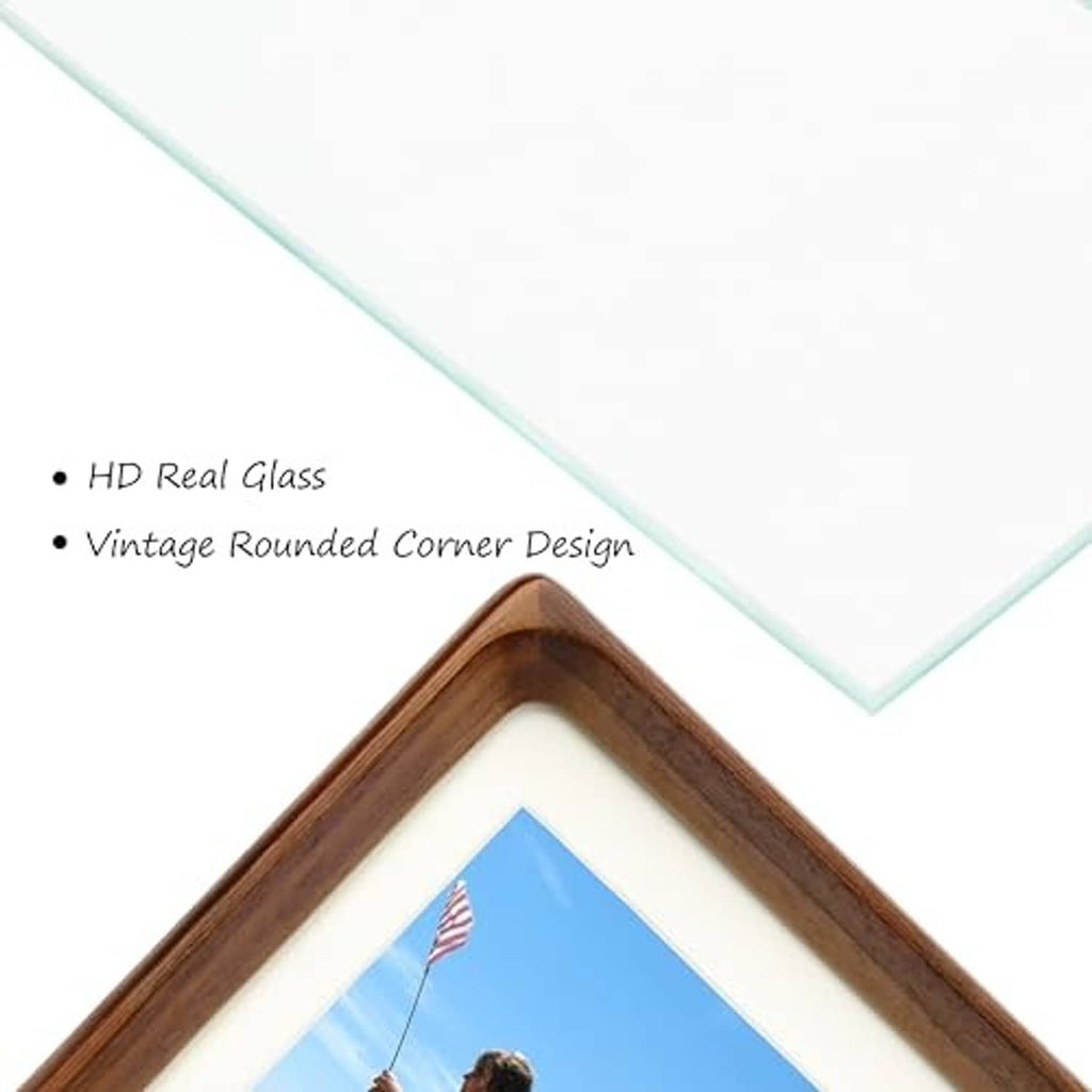 Close-up of rounded corner walnut wood picture frame with glass and white mat