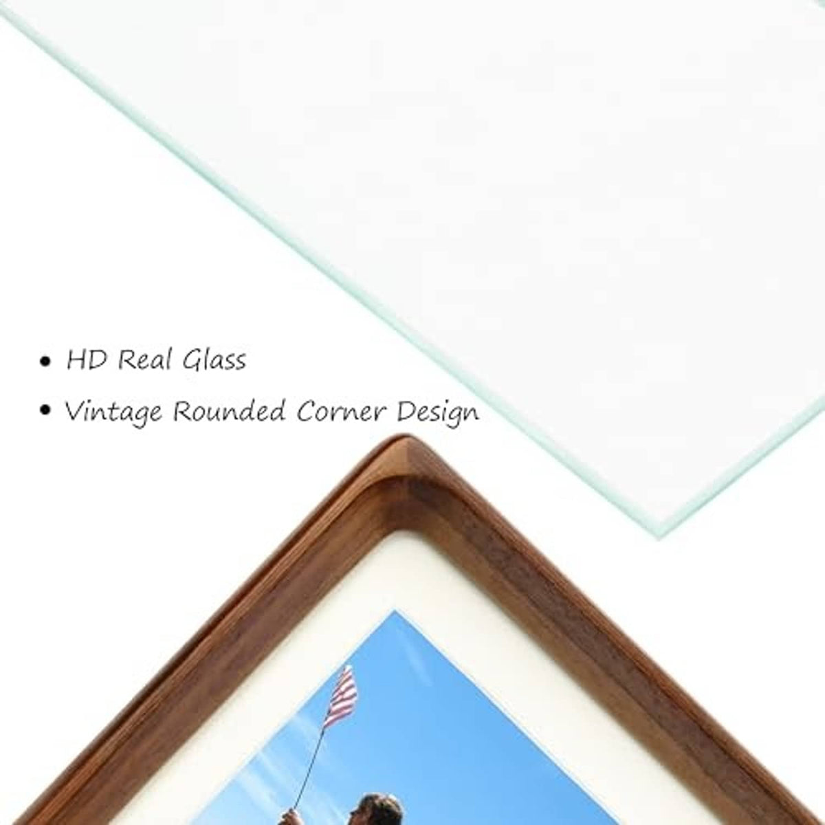 Close-up of rounded corner walnut wood picture frame with glass and white mat