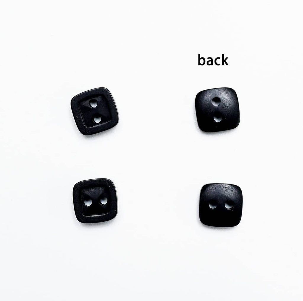 Back view of black square 2-hole resin buttons, visible shank holes