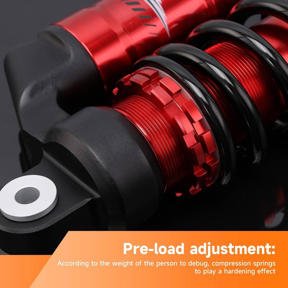 Close-up of red shock reservoir detail with black coil spring and top mount
