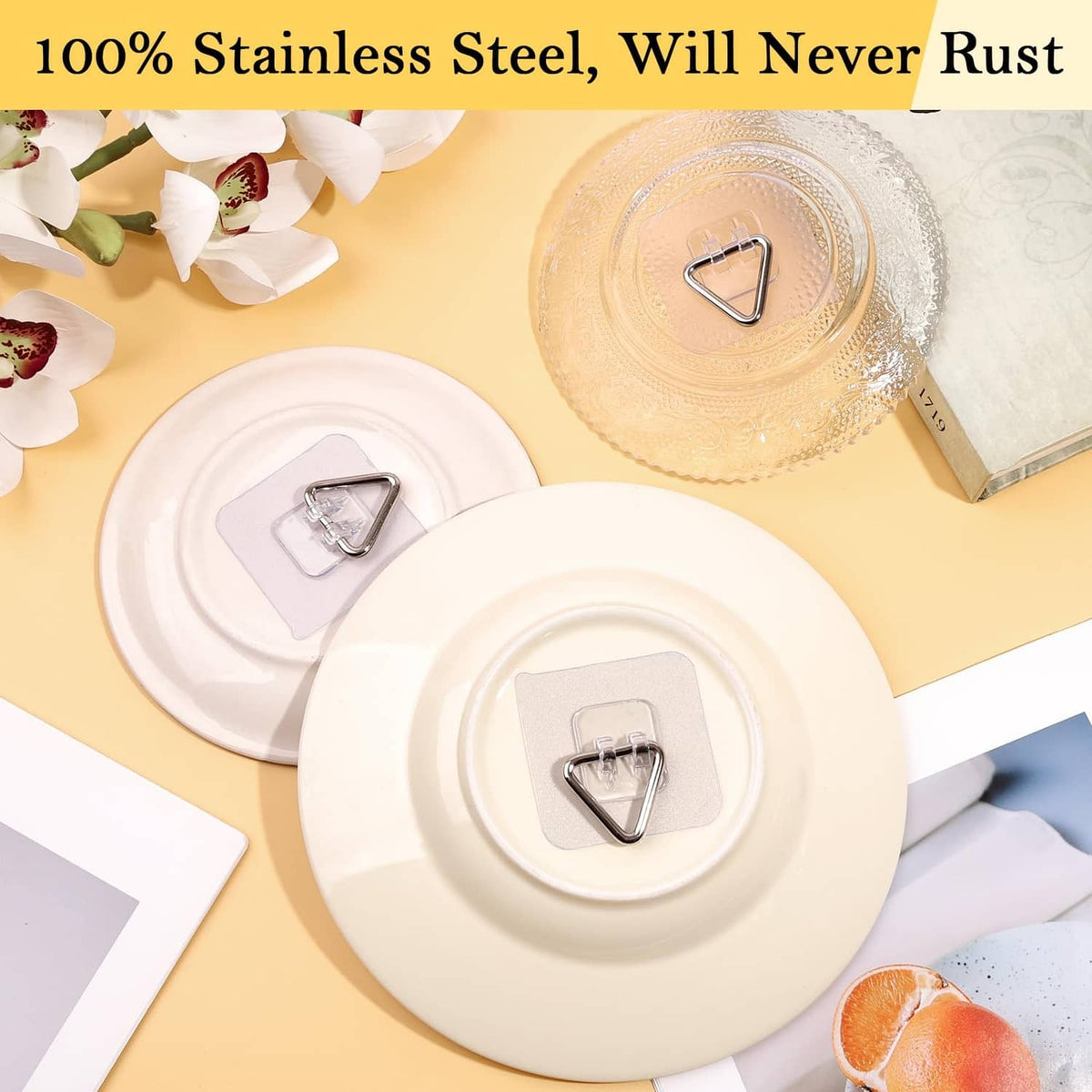 Stainless-steel triangular plate hanger clips on round white adhesive backing plates