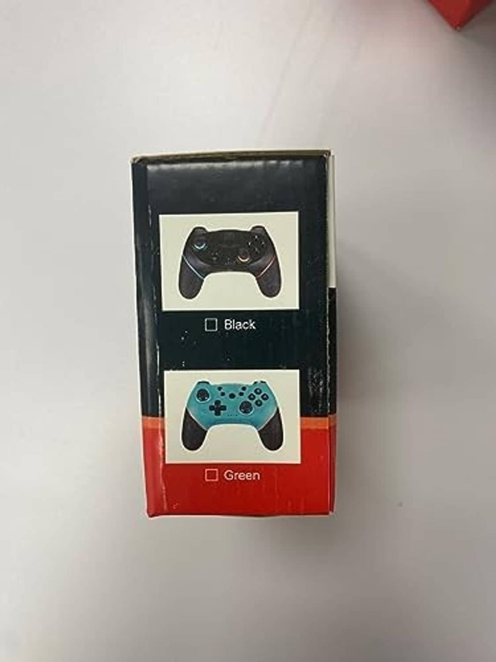 Wireless game controller retail box showing black and green controllers