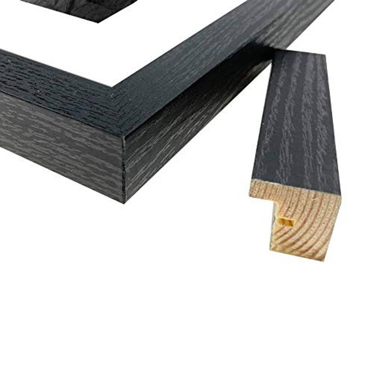 Close-up of black woodgrain picture frame corner and inner edge.
