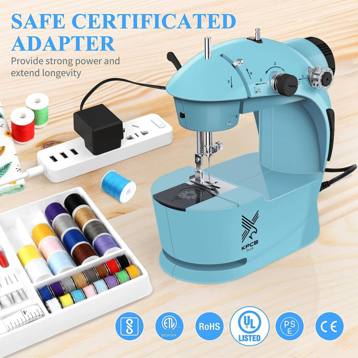Light blue sewing machine with accessory kit including thread spool set and power adapter