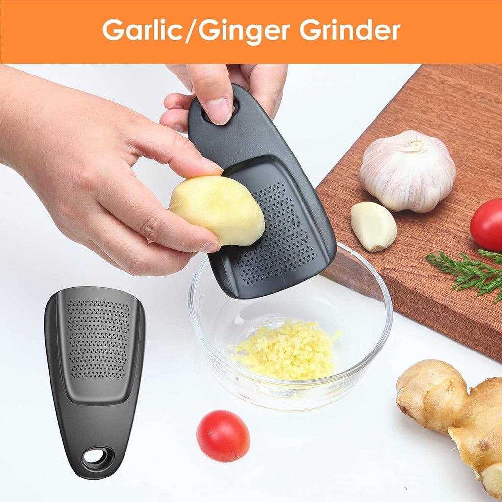 Black garlic/ginger grinder with perforated surface; held over a bowl of grated food