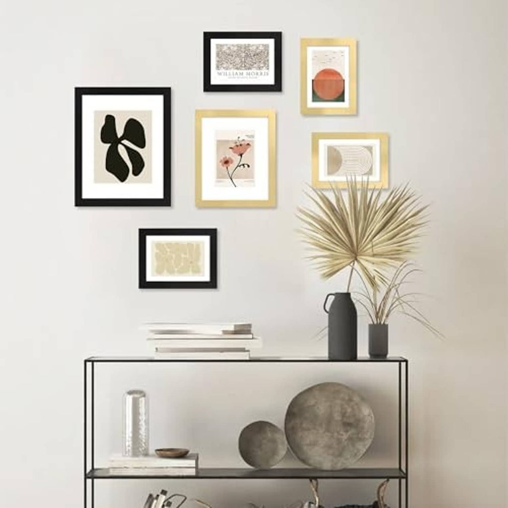 Wall display of black 4x6 picture frames with glass, arranged in a grid