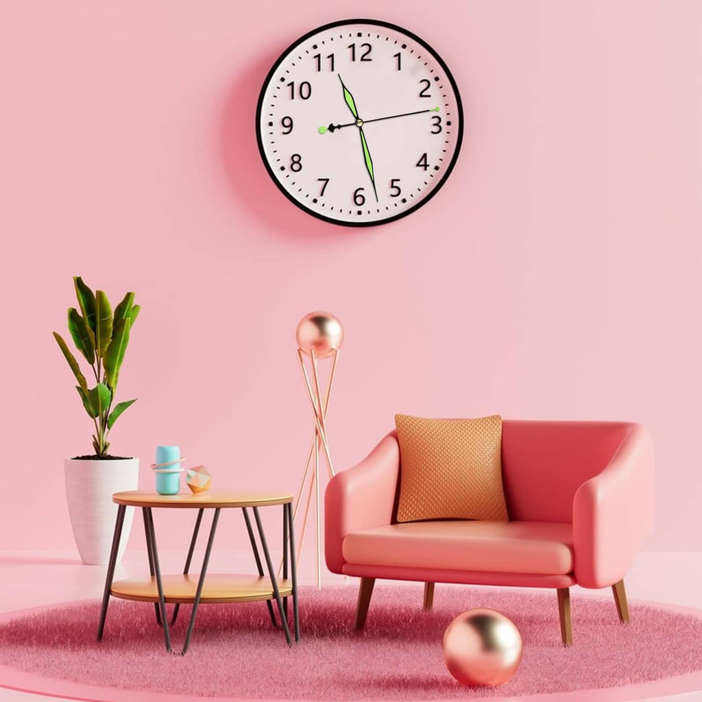 Wall clock with black frame, white dial, and green minute and hour hands