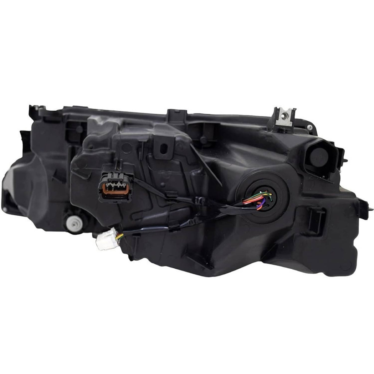 Headlight wiring and connector area on a black housing with exposed electrical plug.