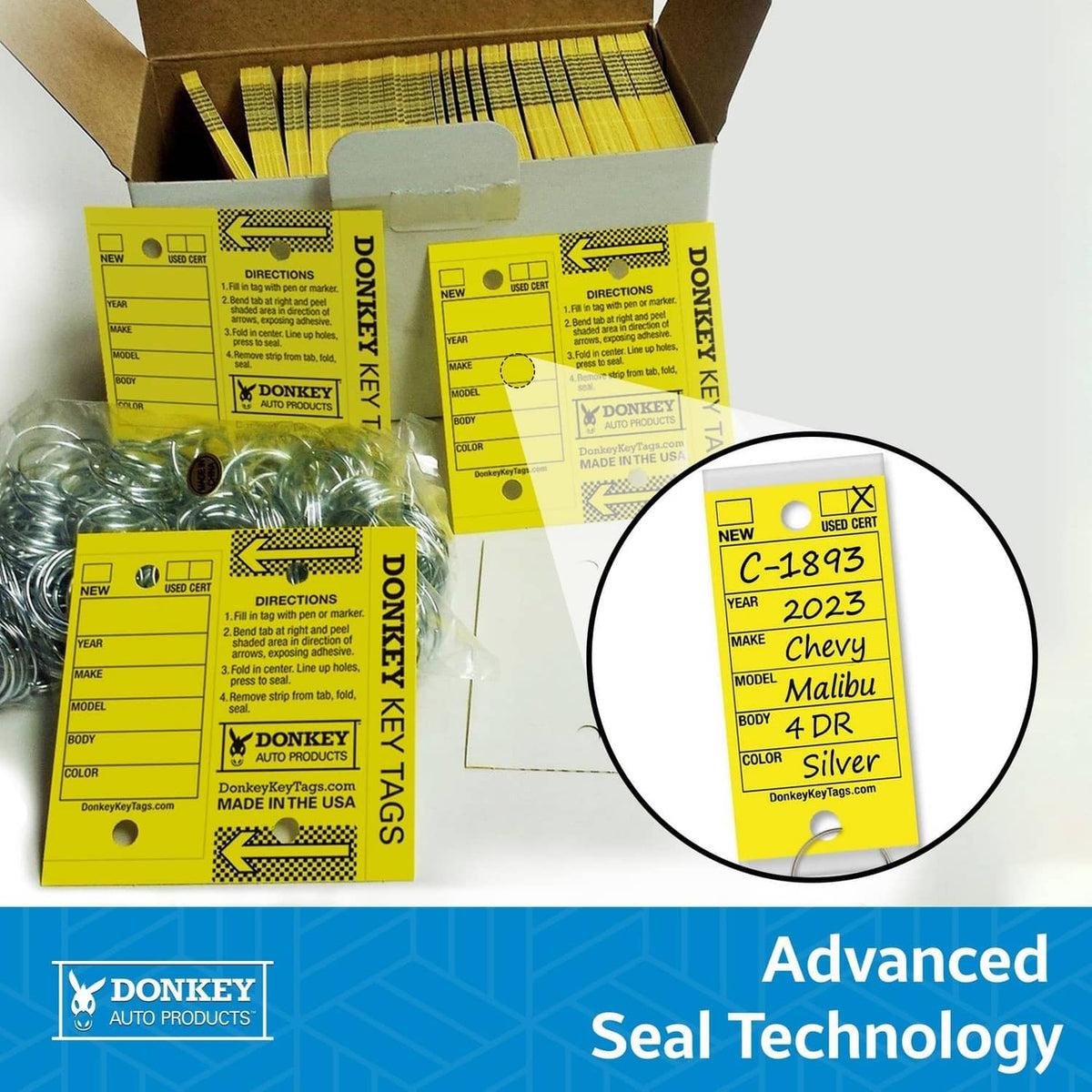 Assorted boxed laminated key tags with metal rings; seal technology label in detail